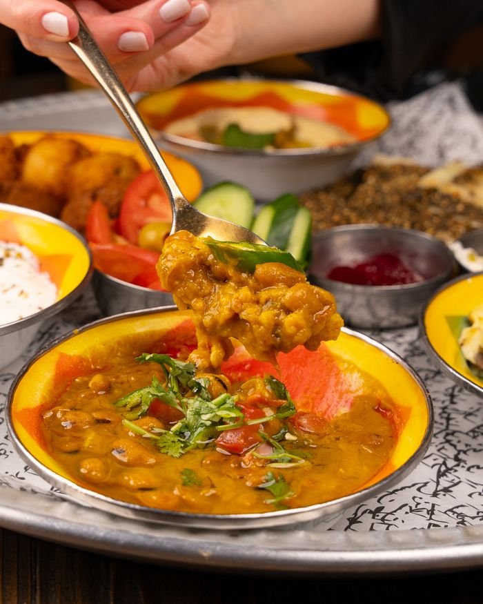 Delicious lentil curry served with fresh cilantro and spices, perfect for dinner.