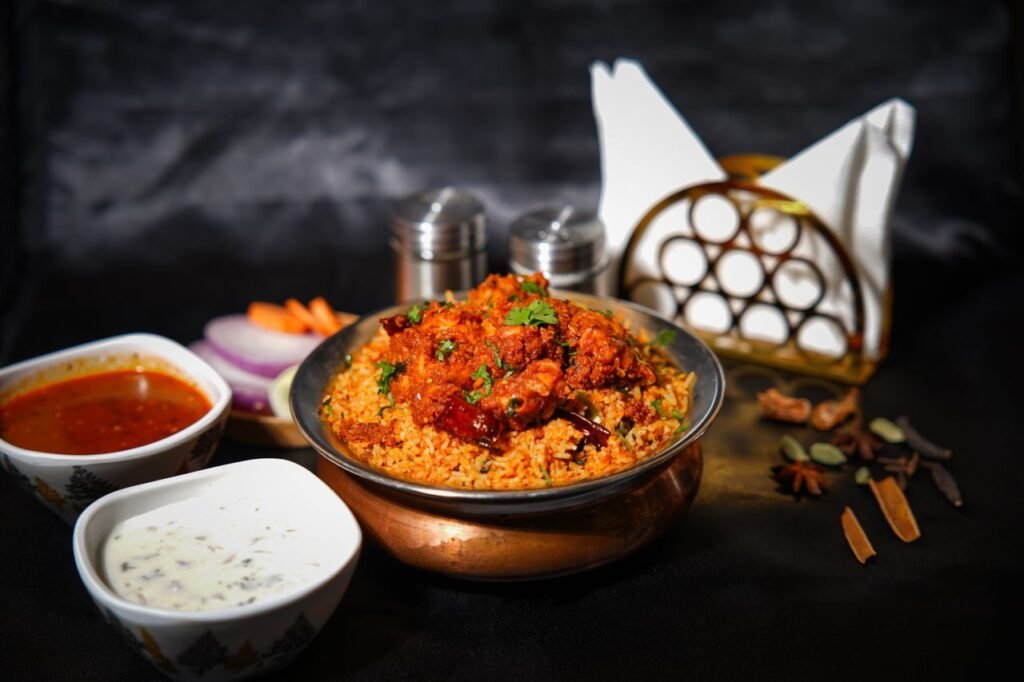 Mouth-watering chicken biryani with spices, sauces, and garnishes, perfect for food lovers.